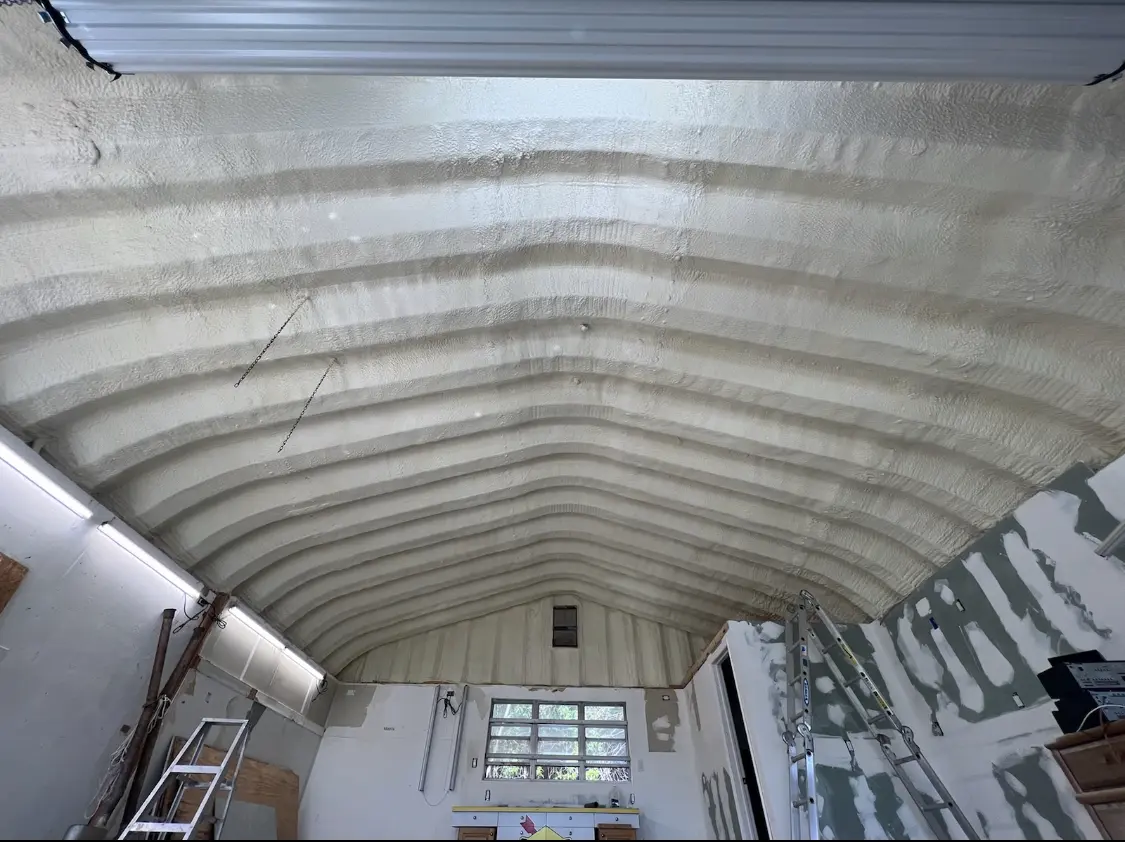 Spray polyurethane foam applied to the underside of a metal roof deck in Hoschton